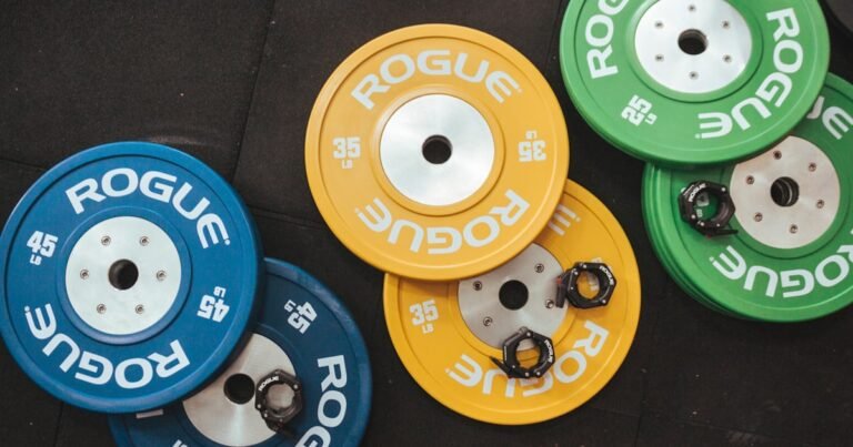 Bumper weight plates stacked on a storage rack